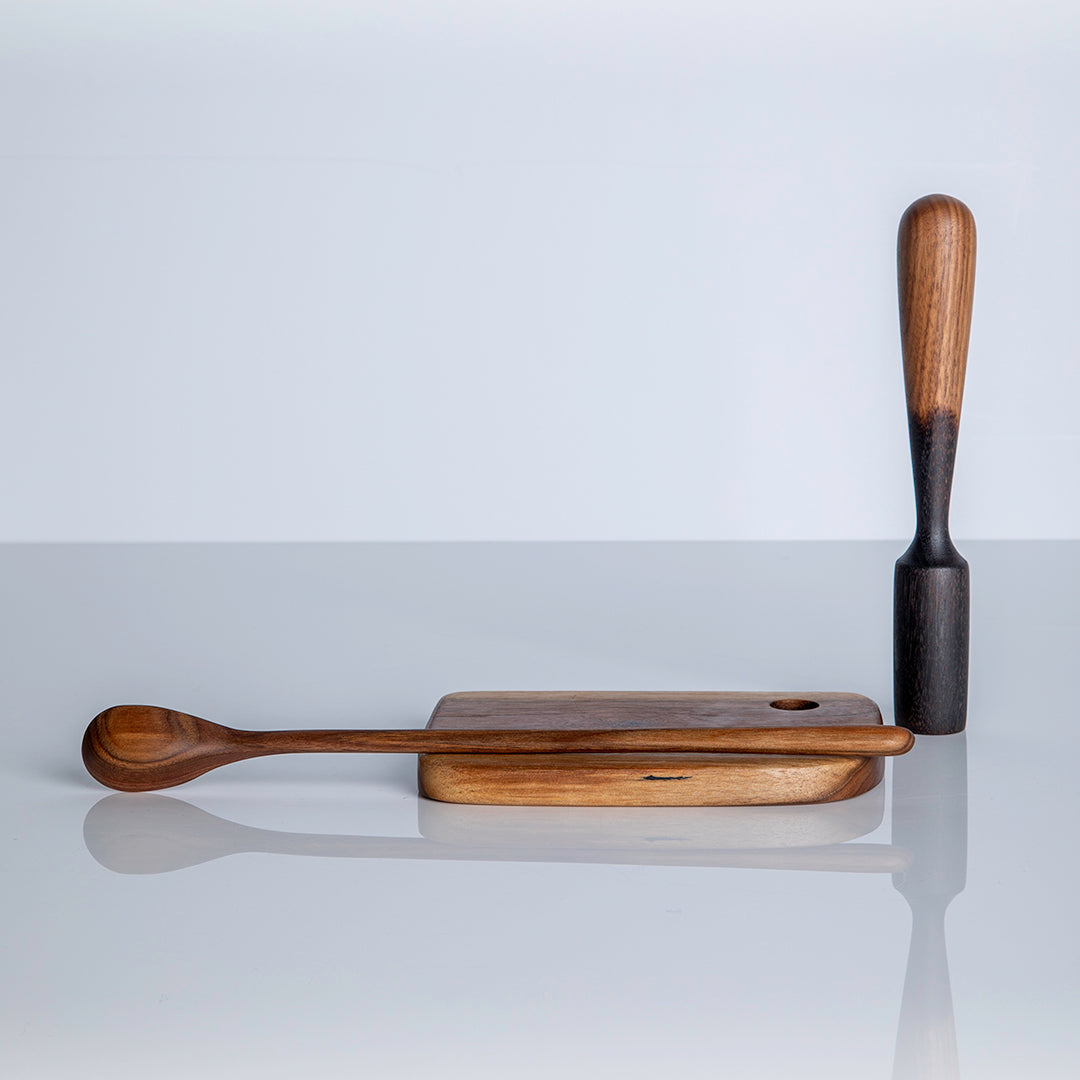 Cutting board with carved long spoon and muddler