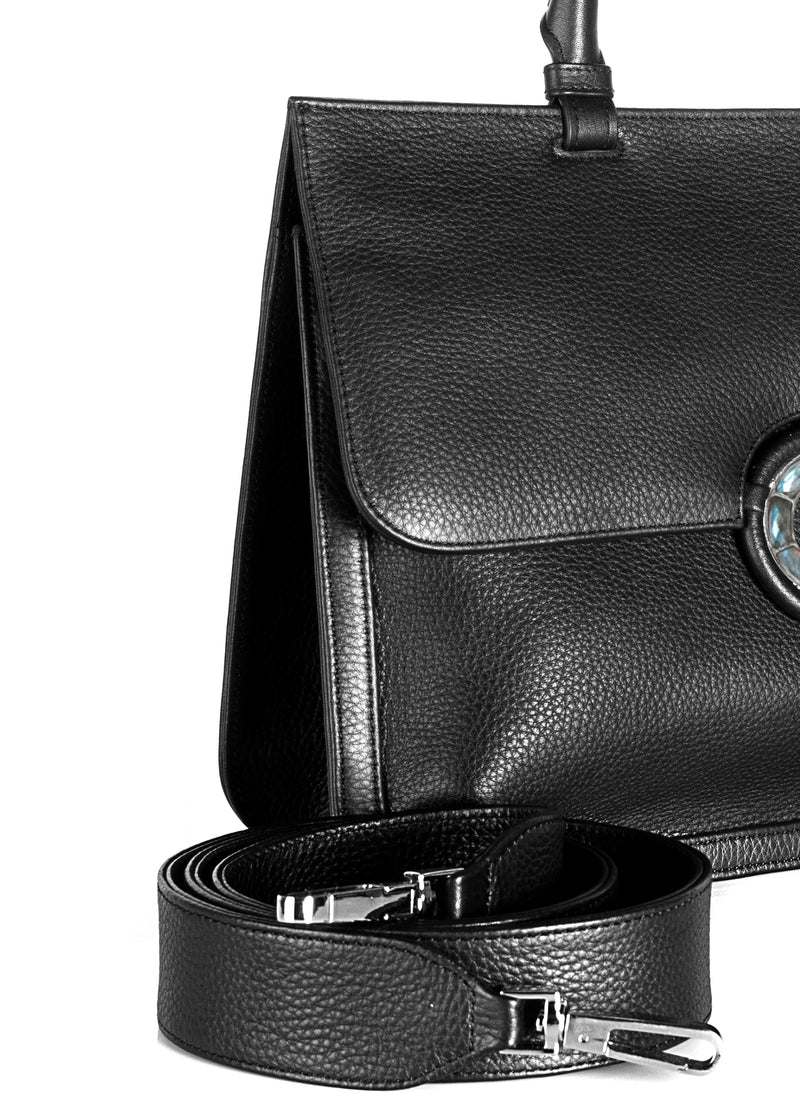 Crossbody strap and side detail on black leather grommet saddle bag - Darby Scott