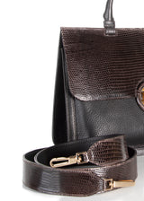 Detail view of crossbody strap and side of brown leather & lizard saddle bag - Darby Scott