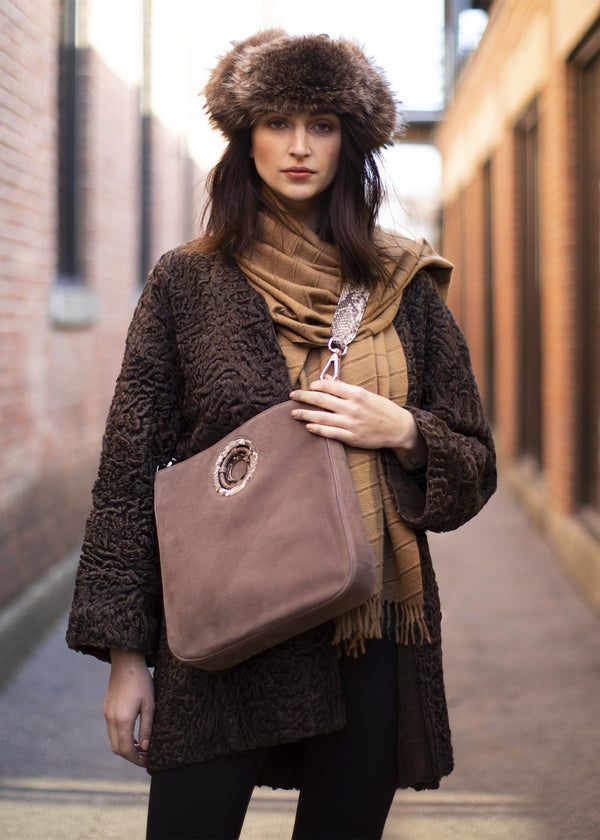 Model carrying a light brown suede Cloe crossbody tote - Darby Scott