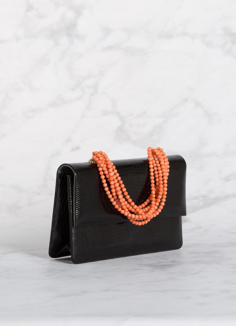 Angled view of Black Lizard and Coral Necklace Handbag - Darby Scott