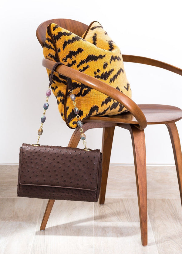Brown ostrich chain & jewel shoulder bag hanging off a mid-century modern chair - Darby Scott