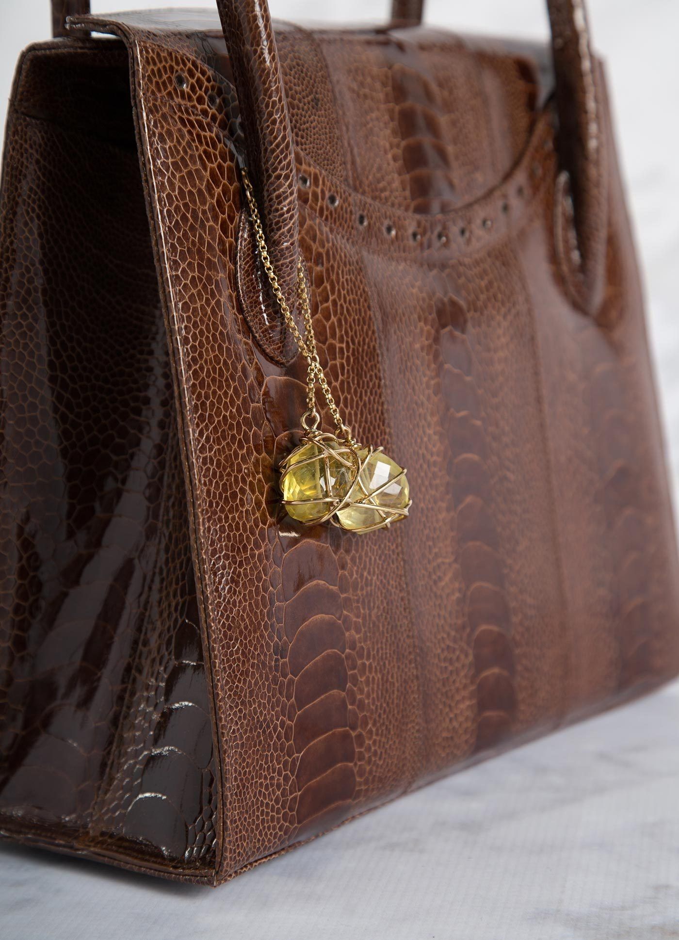 Detail of Citrine Fob on Cognac Ostrich Leg Thompson Tote - Darby Scott