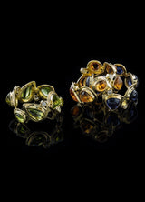 A trio of gemstone & diamond mosaic band rings shown - Darby Scott