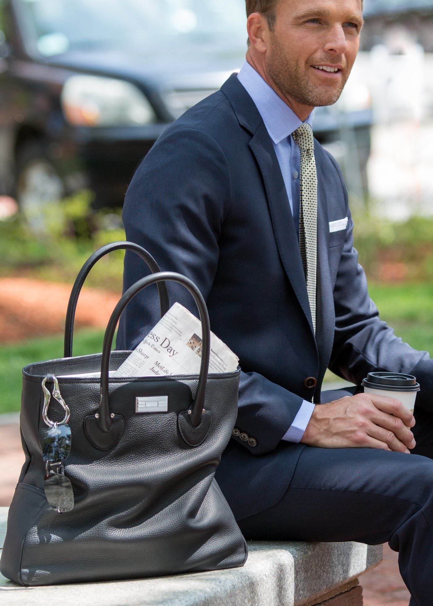 Model with black leather Essex tote beside him - Darby Scott 