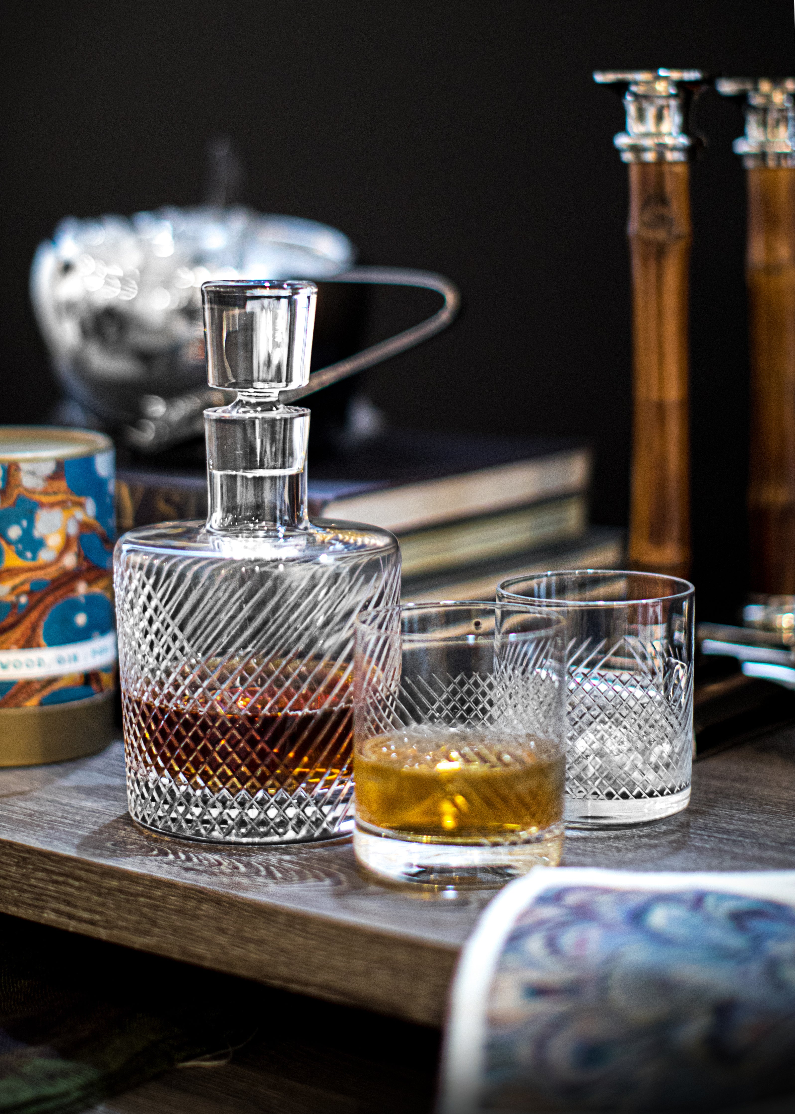 Whiskey Decanter, Rocks Glasses and candlesticks on tabletop