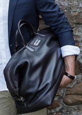 Model Holding a Leather Aspen Duffle Travel Bag - Darby Scott
