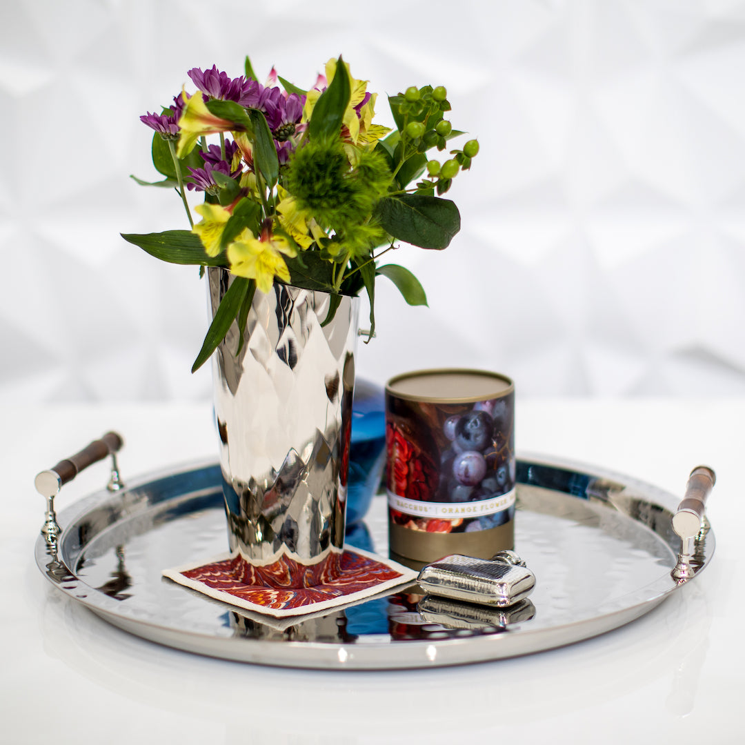 Pitcher with flowers on tray